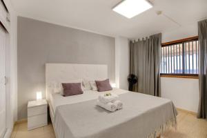 a bedroom with a large bed with a towel on it at Las Fuentes in Arona