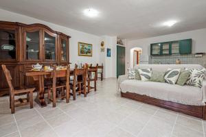 a living room with a couch and a dining room at Casa Elisa in Padru