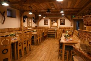 a dining room with wooden tables and chairs at Chata Pieniny in Lesnica +37 photos