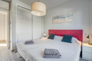 a bedroom with a large bed with a red headboard at Casa Isabel in El Verger +27 photos