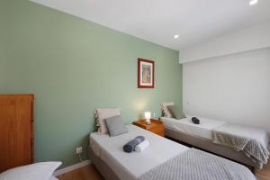 a room with two beds in a room at Flor de Sá in Aveiro