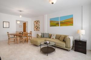 a living room with a couch and a table at Suite Cava in Arrecife