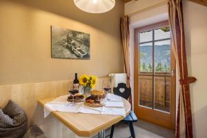 a dining room with a table with glasses of wine at Oberplunerhof - Fewo Bruneck in Colli in Pusteria