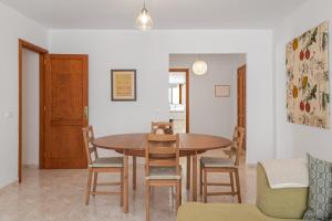 a dining room with a wooden table and chairs at Suite Cava in Arrecife +21 photos