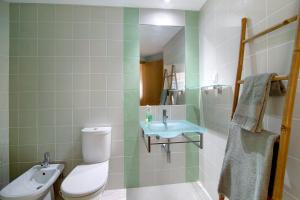 a bathroom with a toilet and a sink at Vista Mar in Cabanas de Tavira +18 photos