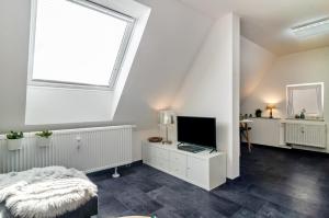 a bedroom with a large window and a tv at Fewo-Keinath in Winterlingen