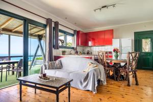 a kitchen and living room with a couch and a table at Villa Koutoupakia in Kefallonia +15 photos
