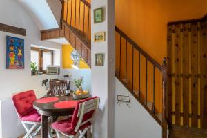 a dining room with a table and red chairs at Casita Kunterbunt in Alicante +17 photos
