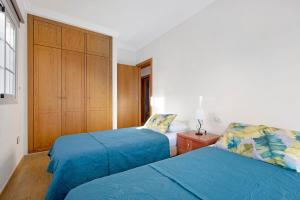 a bedroom with two beds and a cabinet at Casa Luz in La Luz