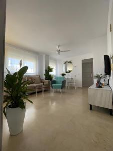 a living room with a couch and a table at El Portil Pinares in El Portil