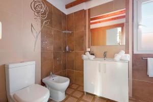 a bathroom with a toilet and a sink at Casa Luz in La Luz +19 photos