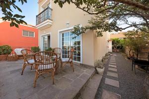 a patio with chairs and a table in front of a house at Casa Luz in La Luz