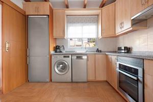 a kitchen with a refrigerator and a dishwasher at Casa Luz in La Luz