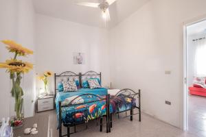 a bedroom with a bed and a ceiling fan at Villa Privata Spiaggia Del Sole in Porto Cesareo
