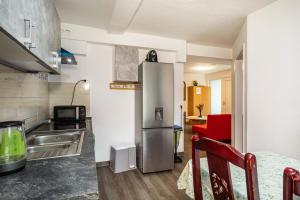 a kitchen with a stainless steel refrigerator in a room at Nguyen und Le in Neukirch