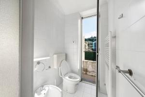 a white bathroom with a toilet and a sink at Casa Terrazza Marino in Levanto +26 photos