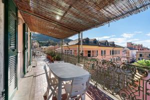 a table and chairs on the balcony of a building at Casa Terrazza Marino in Levanto