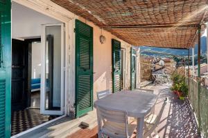 a table and chairs on the balcony of a house at Casa Terrazza Marino in Levanto