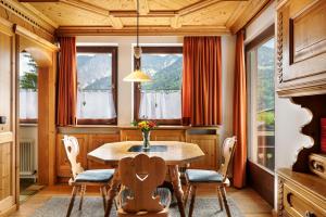 a dining room with a wooden table and chairs at Jordis in Vandans