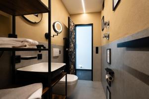 a bathroom with a sink and a toilet and a mirror at Flora und Fauna by Kamelu in Gengenbach +39 photos