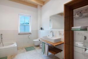 a white bathroom with a sink and a toilet at Chalet Foret - Ferienhaus in Todtnauberg +37 photos