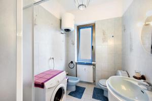 a bathroom with a washing machine and a sink at Casa Vera in Gavi +23 photos
