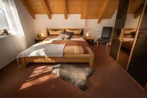 a bedroom with a large bed and a chair at Ferienhaus Hulda in Öhningen
