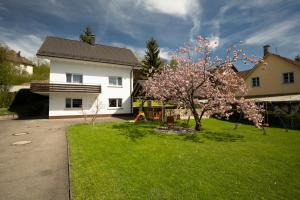 a house with a flowering tree in a yard at Ferienhaus Hulda in Öhningen