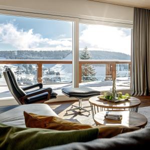 a living room with a large window with a view at Chalet Foret - Ferienhaus in Todtnauberg