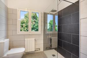 a bathroom with a toilet and a glass shower at Picarus Home in Tacoronte +18 photos