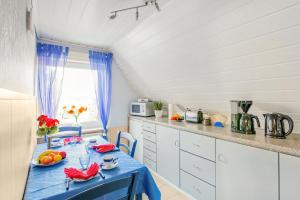 a kitchen with a table with a blue table cloth at Ferienwohnung Itzehoe in Itzehoe