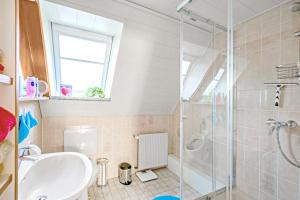 a bathroom with a sink and a shower at Ferienwohnung Itzehoe in Itzehoe +19 photos