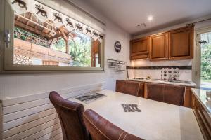 a kitchen with a table and chairs and a window at Au Rêve Savoyard 1 - 2 personnes in Morillon