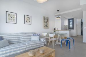 a living room with a couch and a table at Palacio de pilas 22 in Zahara de los Atunes