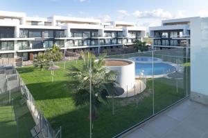 an image of a balcony of a building with a swimming pool at Palacio de pilas 22 in Zahara de los Atunes