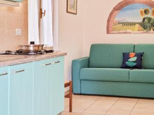a living room with a blue couch and a table at Appartamenti Le Querce App. Mirto in Capoliveri +25 photos