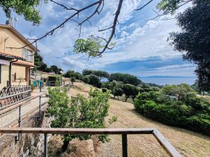 a stairway leading up to a house with a view of a hill at Appartamenti Le Querce App. Mirto in Capoliveri