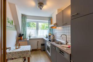 a small kitchen with a sink and a window at Ferienhof An Der Wehle Pellworm in Pellworm