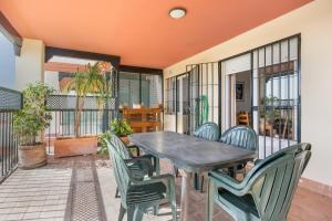 a porch with a table and chairs on a patio at Camaleón 7 in Chipiona