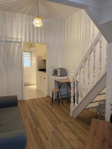 a living room with a staircase leading to a kitchen at Duplex charmant centre Joigny - C1 in Joigny