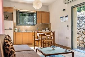 a living room with a table and a kitchen at Alkionides Apartment 1 in Agios Nikitas