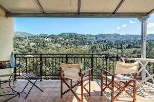 a balcony with chairs and a table and a view at Alkionides Apartment 1 in Agios Nikitas