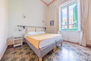 a bedroom with a bed and a large window at Epoque in Messina +64 photos