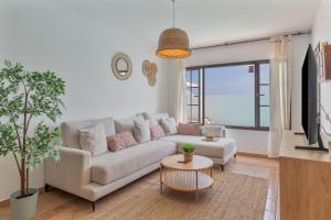 a living room with a white couch and a table at Villa Timanfaya in Tías