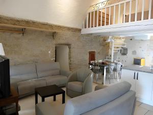 a living room with a couch and a table at L'alouette - Gites Rocheflamme in La Malène