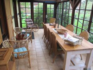 a dining room with a wooden table and chairs at Altes Jägerhaus in Lübbenow +12 photos