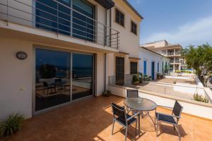 a patio with a table and chairs and a view of the ocean at Casa Mulet in Can Picafort