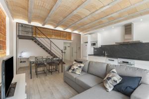 a living room with a couch and a dining room at El racó del Mas in Canet de Mar