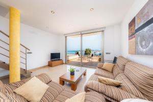 a living room with a couch and a table at Casa Mulet in Can Picafort