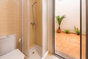 a bathroom with a shower and a toilet with a glass door at Casa Mulet in Can Picafort +18 photos